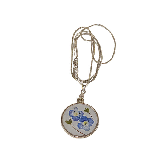 S Styles Bijoux, Handmade silver necklace featuring real pressed blue flowers preserved in resin. A unique and elegant gift, perfect for special occasions.